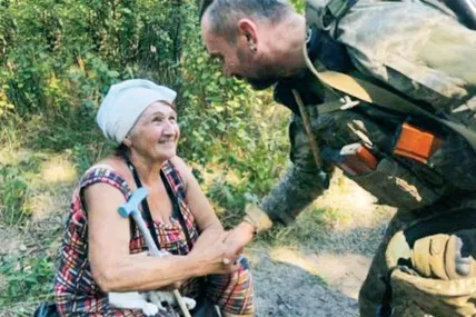 Український воїн вітає жительку визволеного села Роботиного.