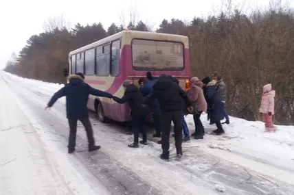 Разом із чоловіками автобус на "скляній" дорозі пхали жінки, дівчина-інвалід...