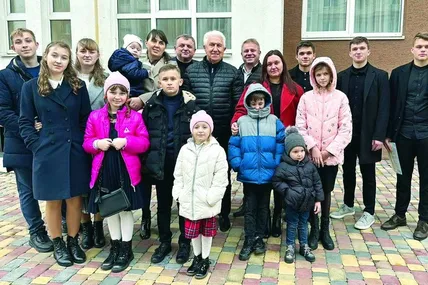 Забудовник Віктор М’ялик (четвертий справа у верхньому ряду) з родинами загиблих волонтерів. Фото Facebook