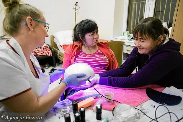 Оксана (посередині) з сестрою Наталею (справа) і косметолог Єва Гробельна під час манікюру, незадовго перед поверненням в Україну. Фото Лукаша Циналевського, Gazeta Wyborcza